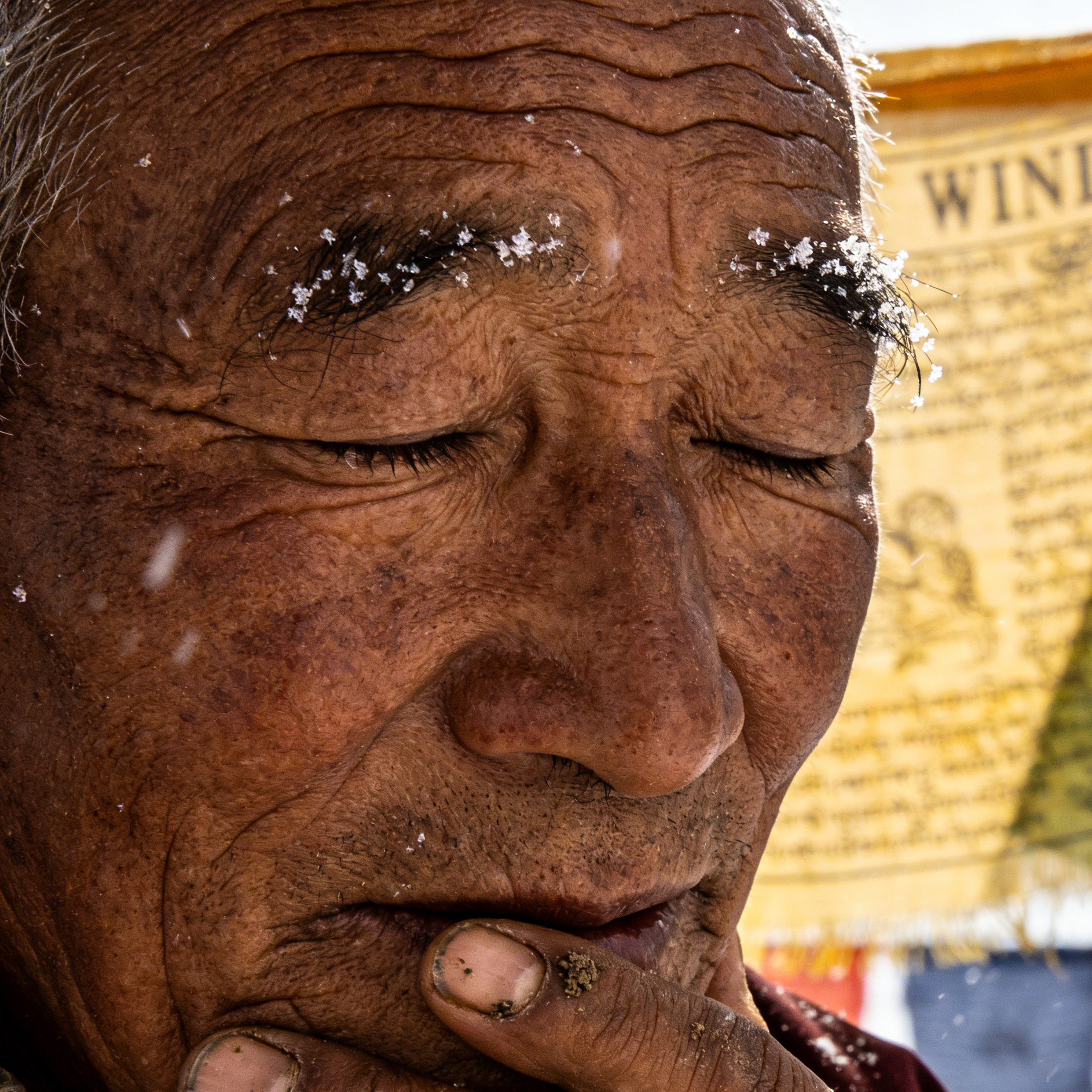 A Black street singer performing in front of BEAT graffiti